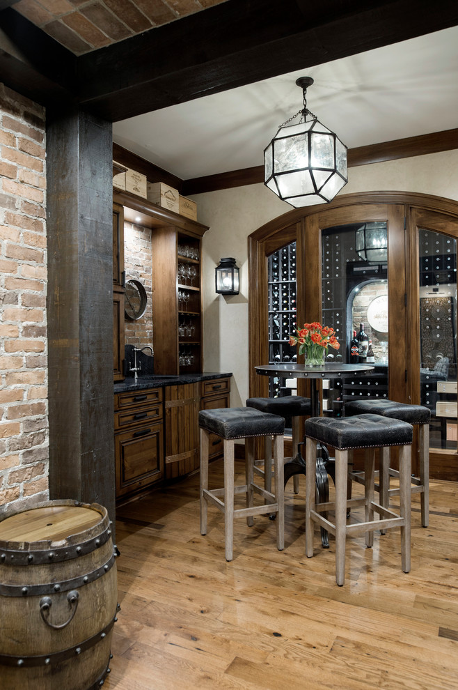 Design ideas for a mid-sized traditional wine cellar in Columbus with medium hardwood floors, display racks and beige floor.