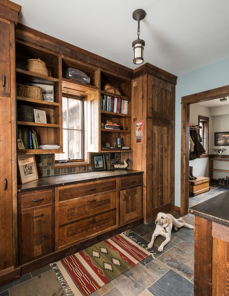 Mudroom - rustic slate floor and multicolored floor mudroom idea with blue walls and a medium wood front door