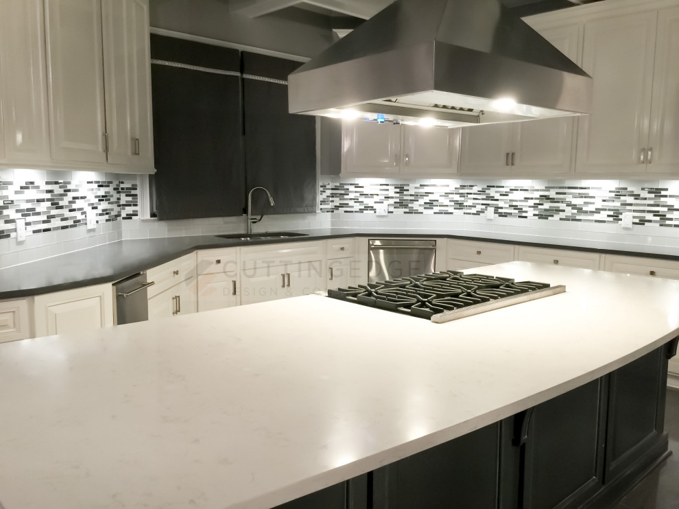 This is an example of a large transitional eat-in kitchen in Atlanta with an undermount sink, raised-panel cabinets, white cabinets, quartz benchtops, grey splashback, mosaic tile splashback, stainless steel appliances, porcelain floors, with island, grey floor, grey benchtop and coffered.