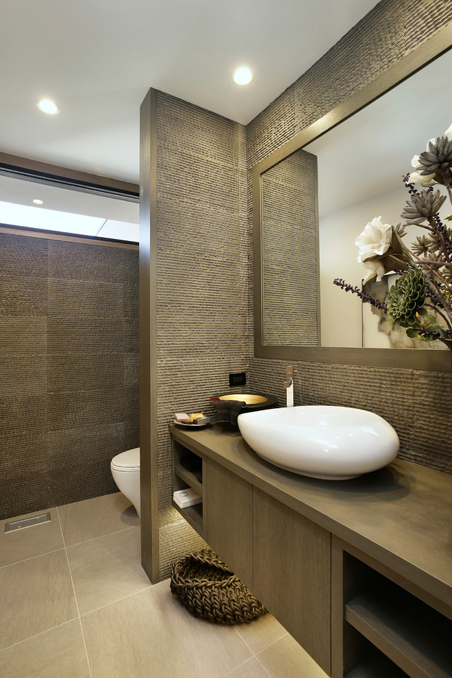 This is an example of a mid-sized contemporary bathroom in Chicago with open cabinets, brown cabinets, gray tile, cement tile, brown walls, ceramic floors, a vessel sink, concrete benchtops and brown floor.
