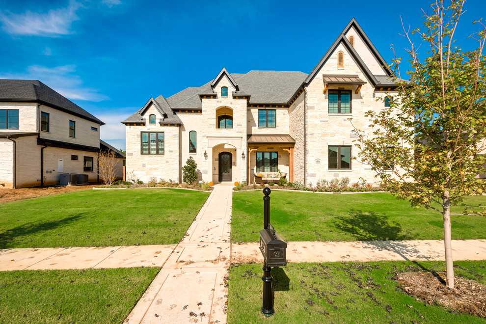 Photo of a large transitional two-storey white exterior in Dallas with stone veneer.