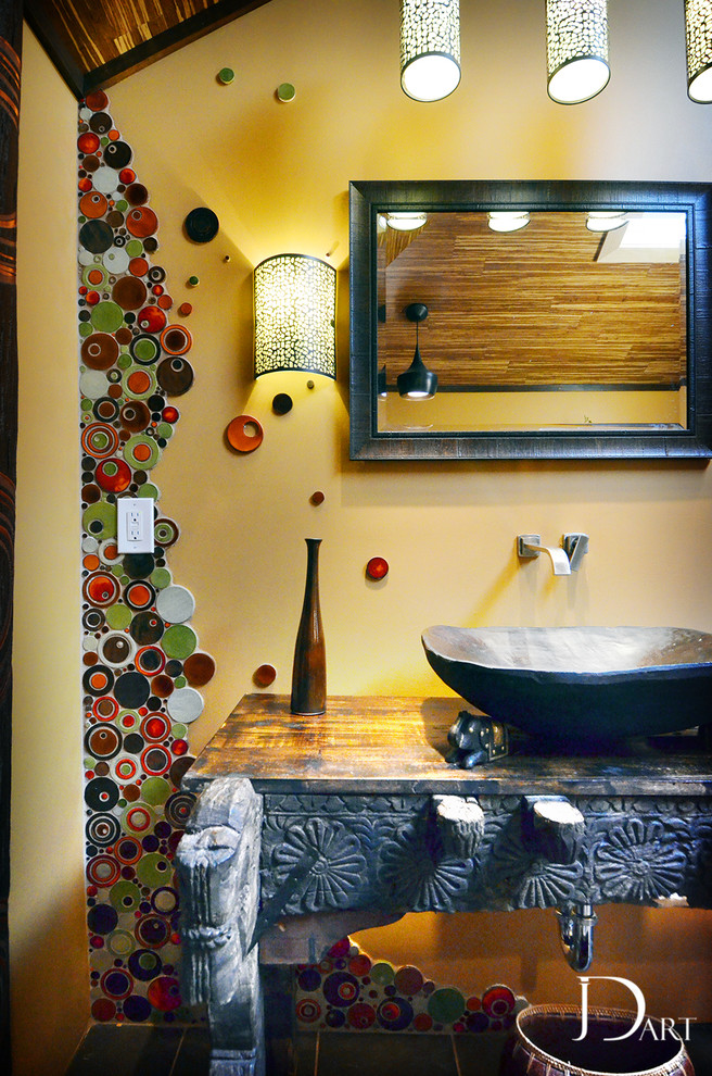 Photo of a large eclectic master bathroom in Other with a vessel sink, a freestanding tub, a corner shower, a one-piece toilet, multi-coloured tile, mosaic tile, open cabinets, wood benchtops and brown walls.