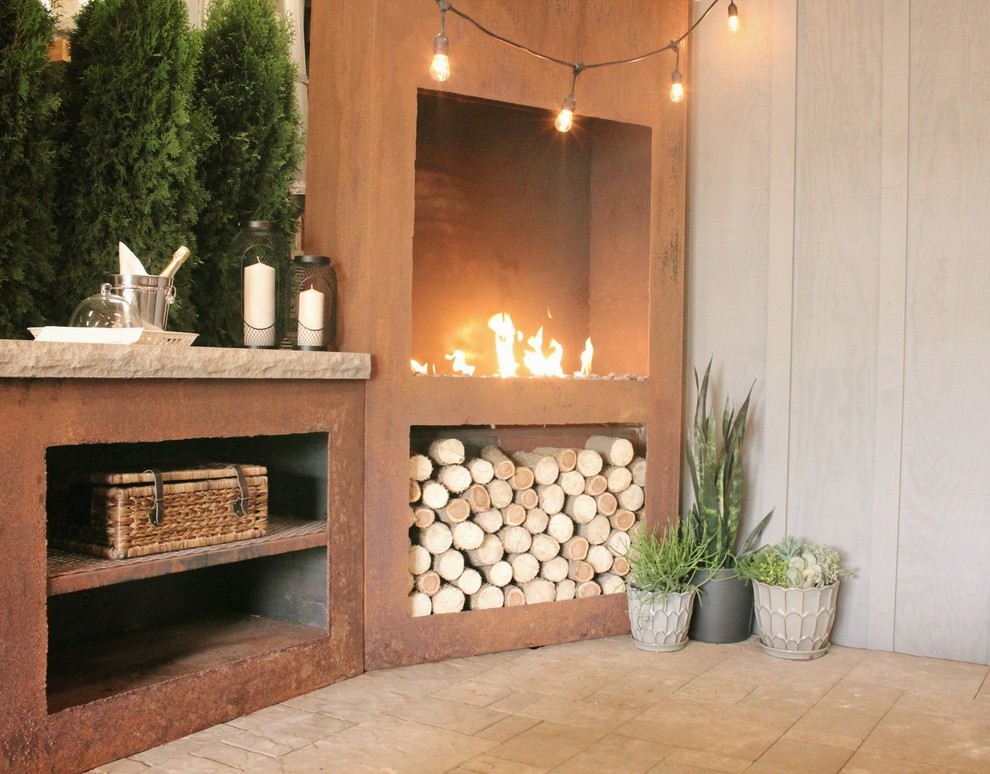 Photo of a mid-sized country patio in Other with with fireplace.