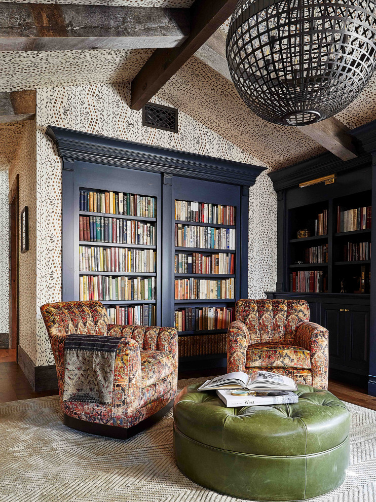 Photo of a country home office in Other with a library, dark hardwood floors, brown floor, vaulted, wallpaper and white walls.