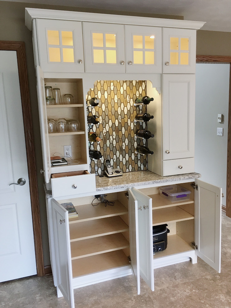 Eat-in kitchen - large transitional l-shaped vinyl floor and beige floor eat-in kitchen idea with a double-bowl sink, recessed-panel cabinets, white cabinets, granite countertops, brown backsplash, ceramic backsplash, stainless steel appliances and an island