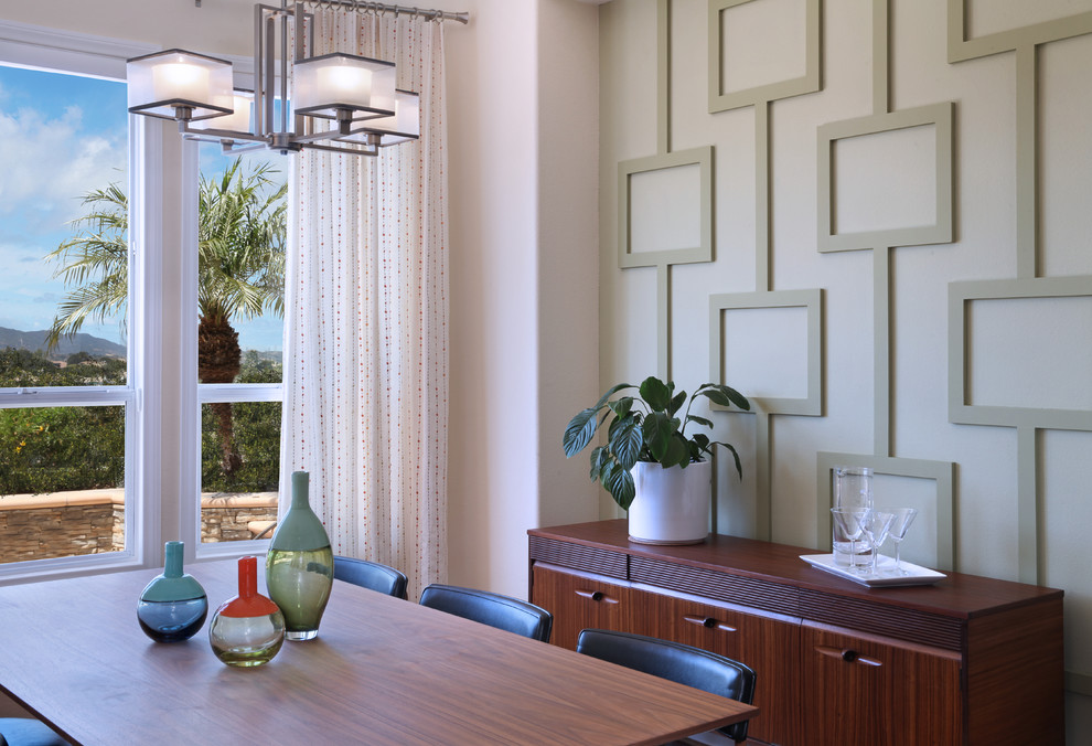 Design ideas for a mid-sized midcentury dining room in Orange County with green walls and medium hardwood floors.