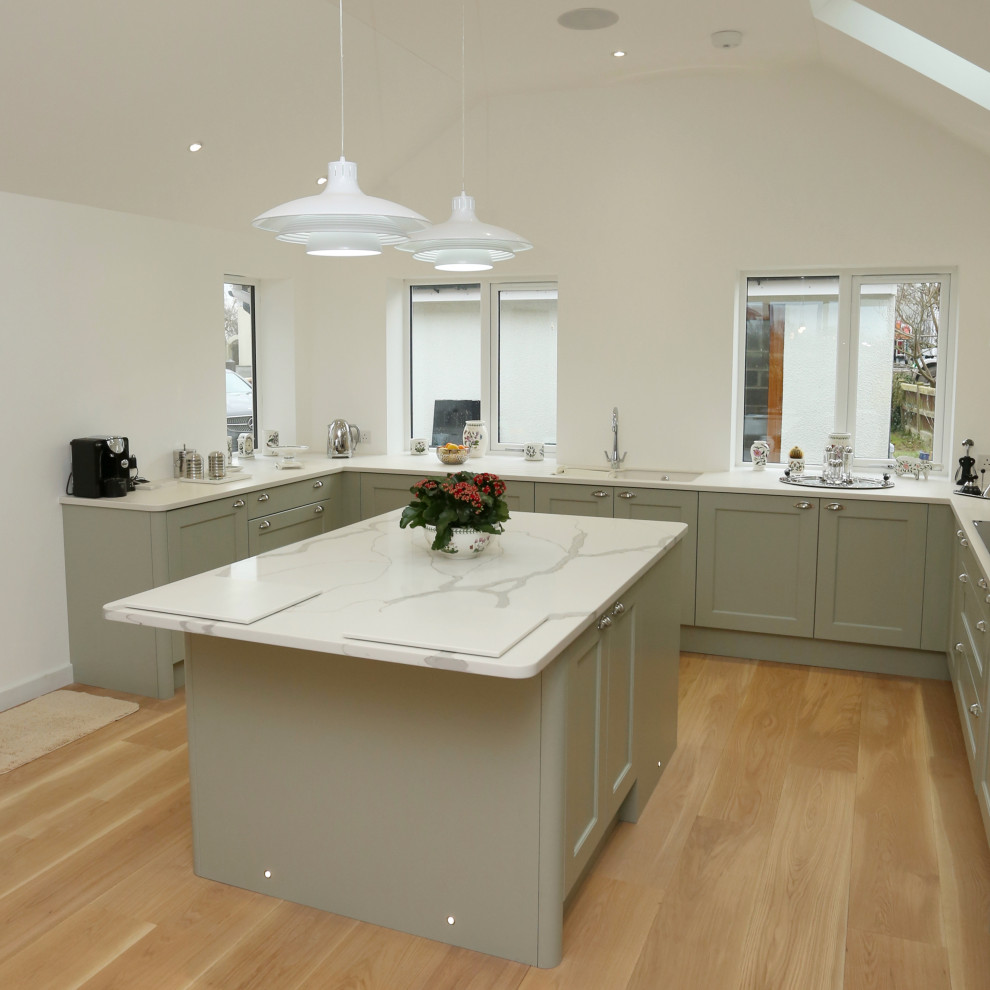 Inspiration for a large traditional u-shaped eat-in kitchen in Other with an integrated sink, shaker cabinets, green cabinets, solid surface benchtops, stainless steel appliances, with island and white benchtop.