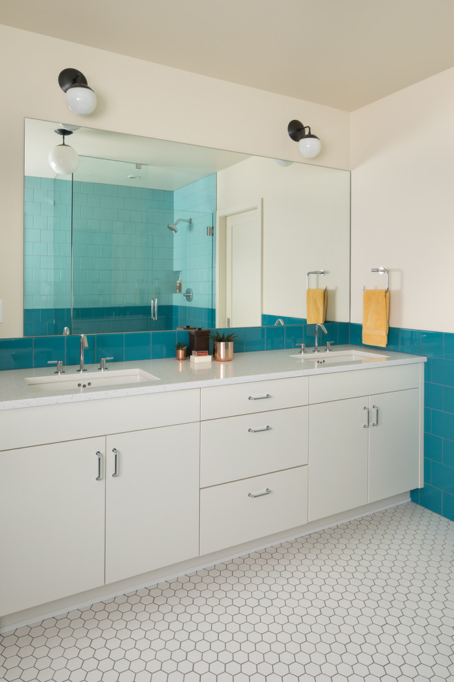 Large modern master bathroom in Portland with flat-panel cabinets, white cabinets, a drop-in tub, a corner shower, blue tile, porcelain tile, white walls, porcelain floors, an undermount sink, recycled glass benchtops, white floor and a hinged shower door.