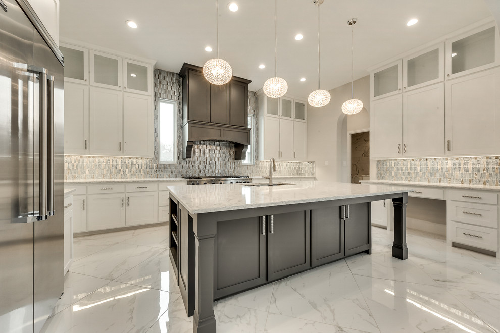 Large transitional u-shaped open plan kitchen in Dallas with an undermount sink, recessed-panel cabinets, white cabinets, quartzite benchtops, metallic splashback, metal splashback, stainless steel appliances, marble floors, with island, white floor and white benchtop.