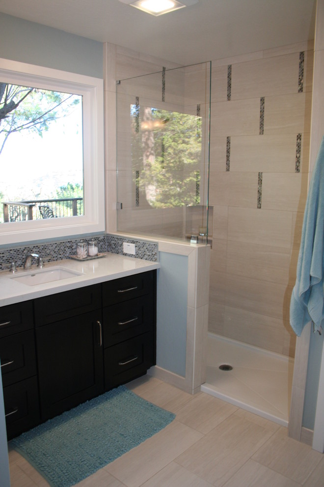 Inspiration for a mid-sized beach style kids bathroom in San Francisco with an undermount sink, shaker cabinets, dark wood cabinets, engineered quartz benchtops, a corner shower, a two-piece toilet, beige tile, porcelain tile, blue walls and porcelain floors.