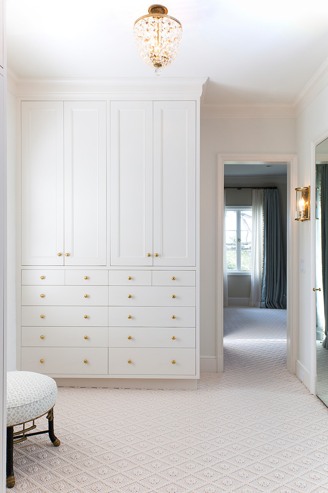 This is an example of a transitional women's dressing room in San Francisco with recessed-panel cabinets, white cabinets, carpet and yellow floor.