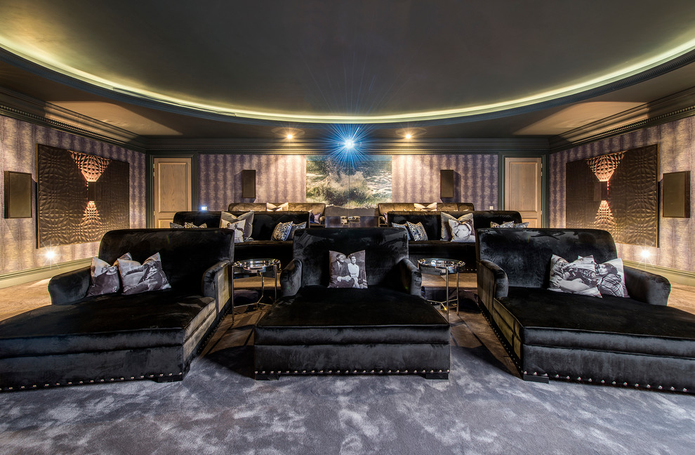 Photo of a large modern enclosed home theatre in Surrey with purple walls, carpet, a projector screen and grey floor.