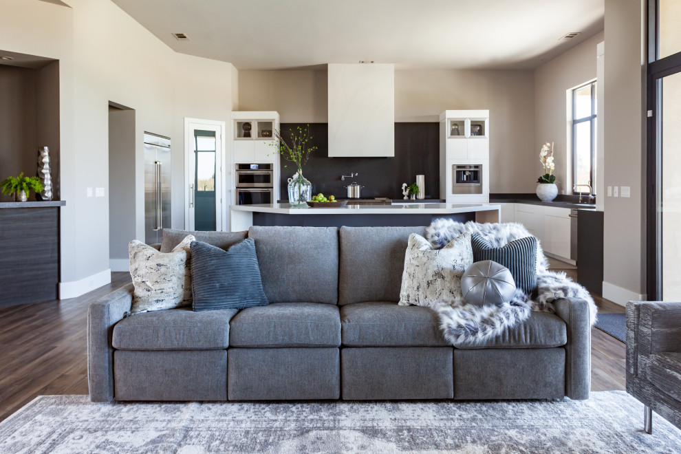 Design ideas for a large contemporary open concept family room in Sacramento with grey walls, vinyl floors, a standard fireplace, a concrete fireplace surround, a wall-mounted tv and brown floor.