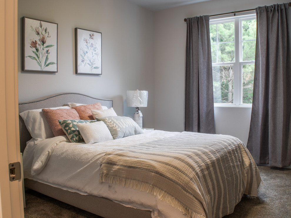 This is an example of a mid-sized country guest bedroom in Other with grey walls, carpet and grey floor.
