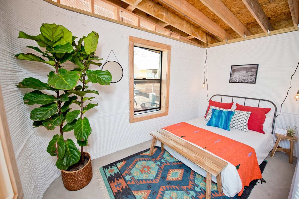 Example of a mid-sized urban master bedroom design in Austin with white walls and no fireplace