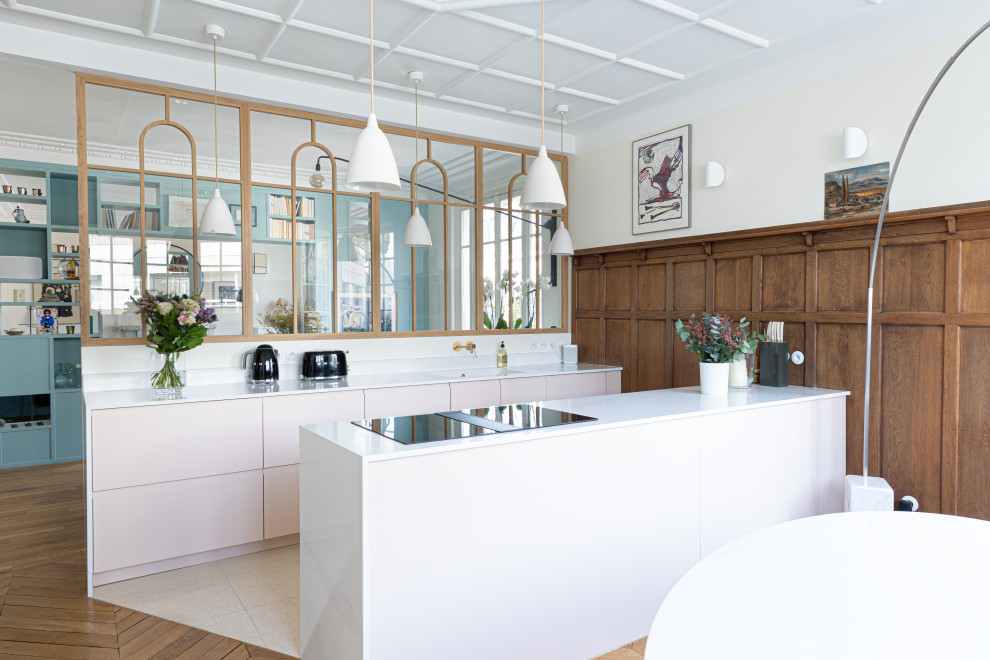 Photo of a large transitional galley open plan kitchen in Paris with a single-bowl sink, beaded inset cabinets, pink cabinets, quartzite benchtops, white splashback, engineered quartz splashback, panelled appliances, terrazzo floors, with island, beige floor, white benchtop and coffered.