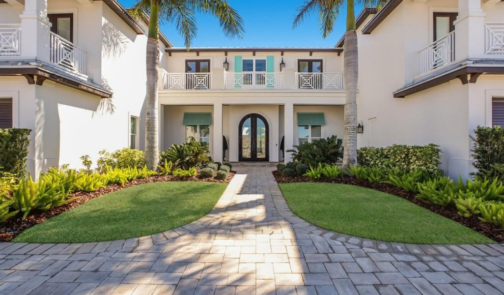 This is an example of an expansive contemporary front door in Tampa with white walls, terrazzo floors, a double front door, a dark wood front door, white floor and vaulted.