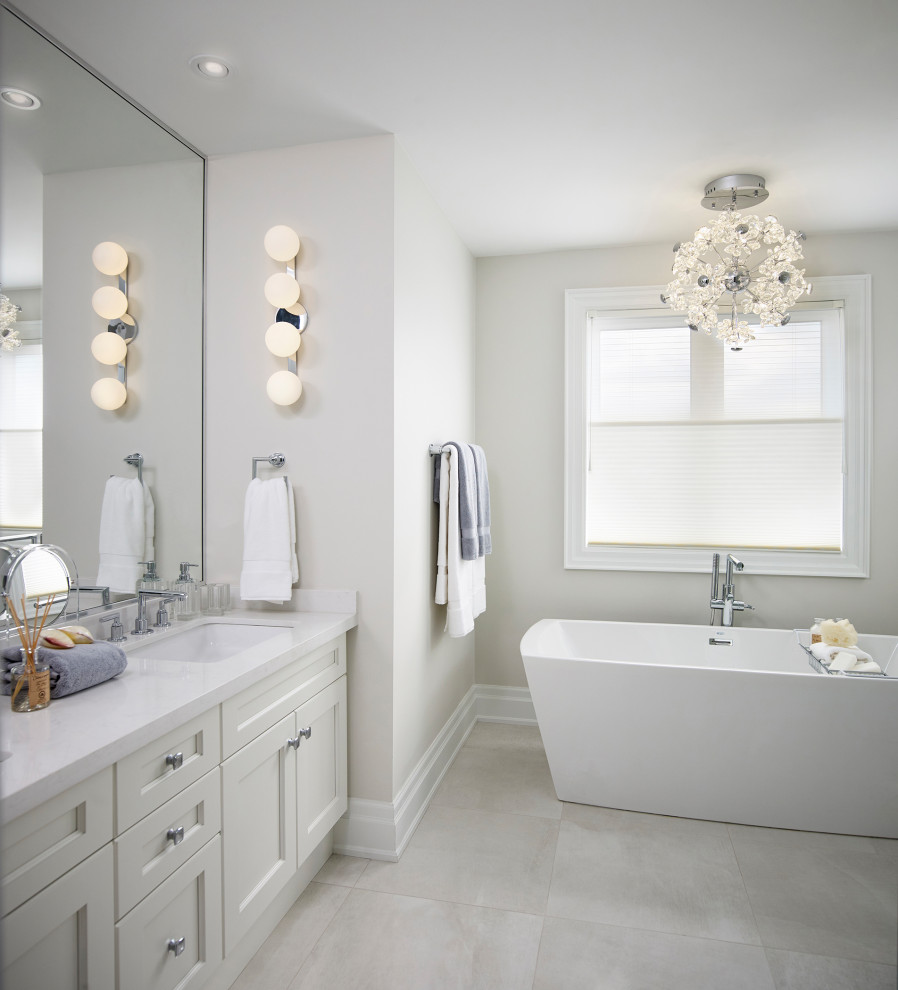 Photo of a mid-sized transitional master bathroom in Toronto with shaker cabinets, beige cabinets, a freestanding tub, an open shower, white walls, porcelain floors, an undermount sink, engineered quartz benchtops, beige floor, a hinged shower door, white benchtops, a double vanity and a built-in vanity.