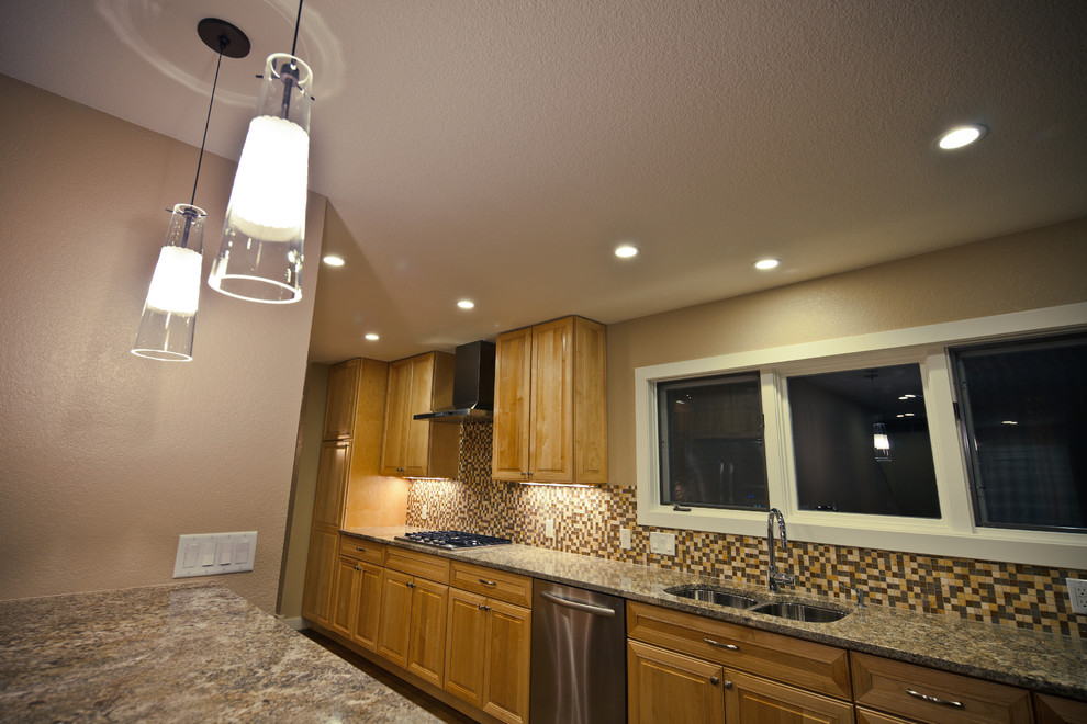 Enclosed kitchen - mid-sized transitional galley medium tone wood floor and brown floor enclosed kitchen idea in Denver with a double-bowl sink, raised-panel cabinets, medium tone wood cabinets, granite countertops, multicolored backsplash, mosaic tile backsplash, stainless steel appliances and no island