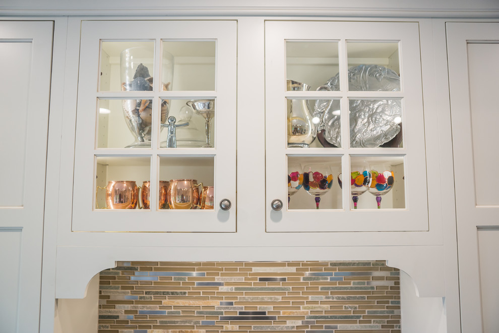 Huge transitional l-shaped medium tone wood floor eat-in kitchen photo in Birmingham with an undermount sink, recessed-panel cabinets, white cabinets, granite countertops, multicolored backsplash, glass tile backsplash, stainless steel appliances and an island