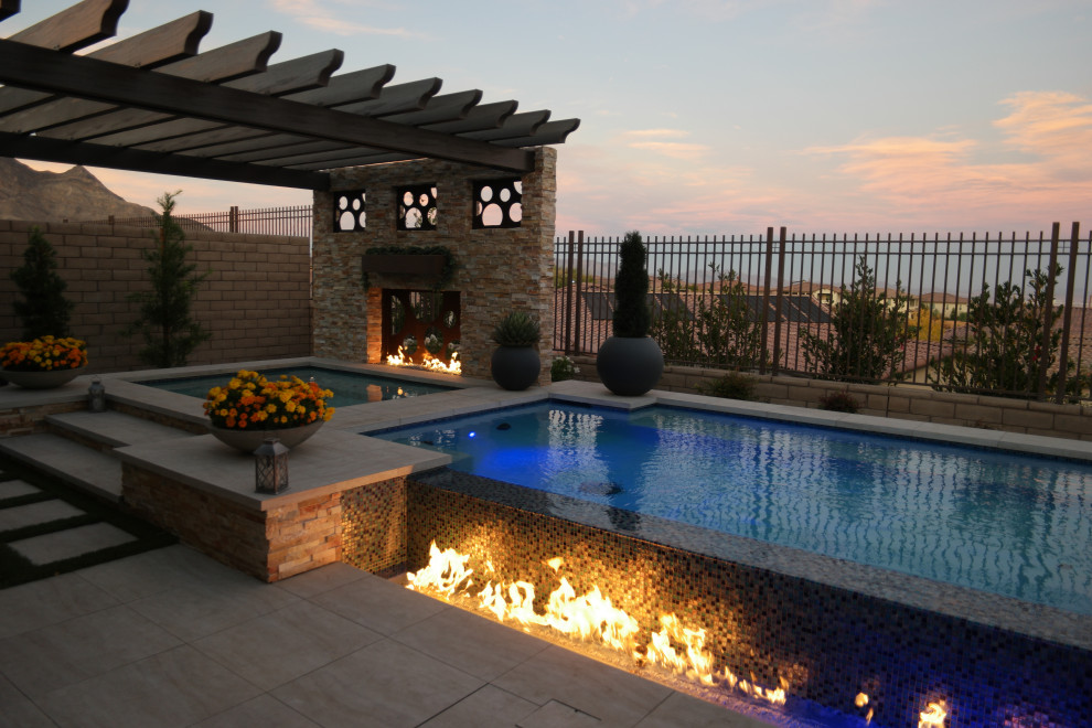 Mid-sized transitional backyard tile and rectangular aboveground pool landscaping photo in Las Vegas
