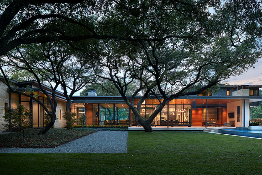 This is an example of a contemporary two-storey white house exterior in Dallas with metal siding and a metal roof.