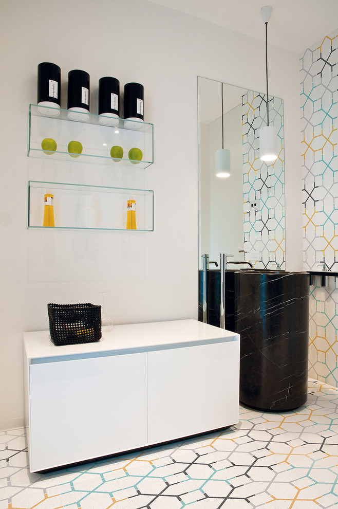 Small contemporary master bathroom in Bologna with flat-panel cabinets, white cabinets, multi-coloured tile, mosaic tile, multi-coloured walls, a pedestal sink and ceramic floors.