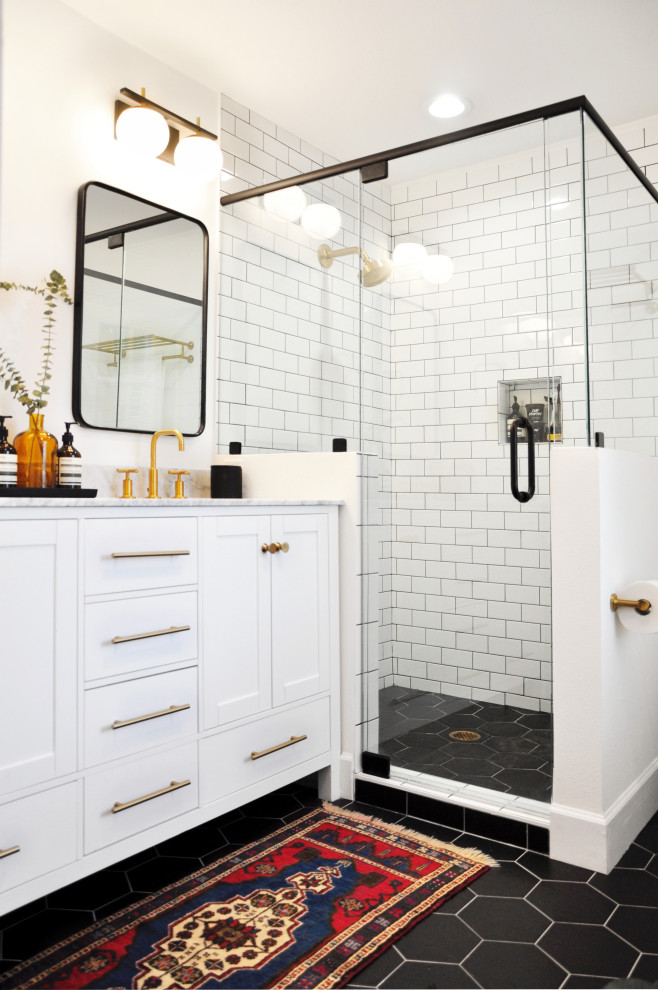 Inspiration for a transitional 3/4 bathroom in Orlando with shaker cabinets, white cabinets, a corner shower, white tile, subway tile, white walls, an undermount sink, black floor, a hinged shower door and multi-coloured benchtops.