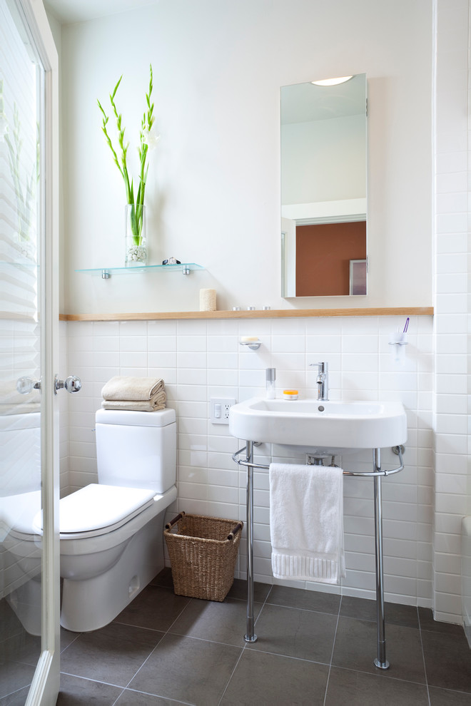 Traditional bathroom in San Francisco with a console sink and white tile.