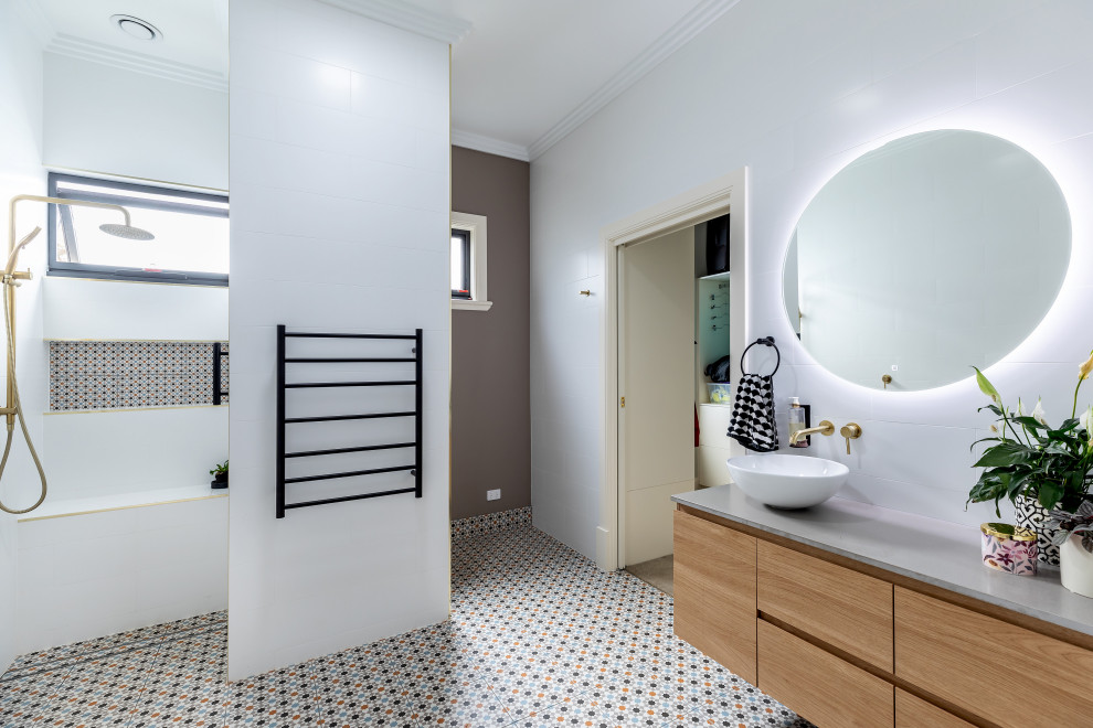 Design ideas for a contemporary bathroom in Adelaide with flat-panel cabinets, medium wood cabinets, a curbless shower, white tile, a vessel sink, multi-coloured floor, grey benchtops, a niche, a shower seat, a single vanity and a floating vanity.
