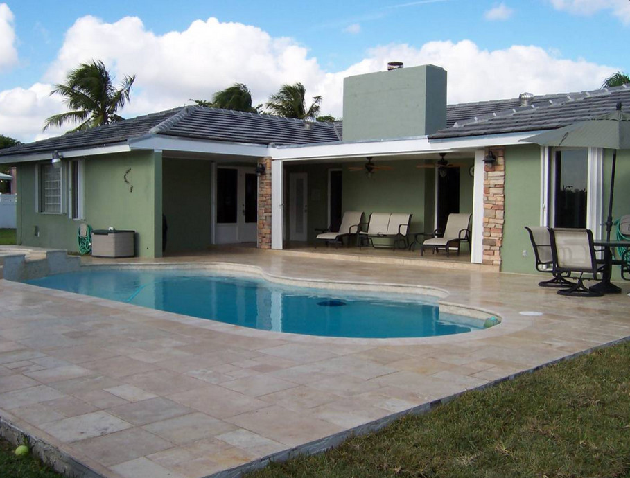 Transitional backyard tile and custom-shaped natural hot tub photo in Miami