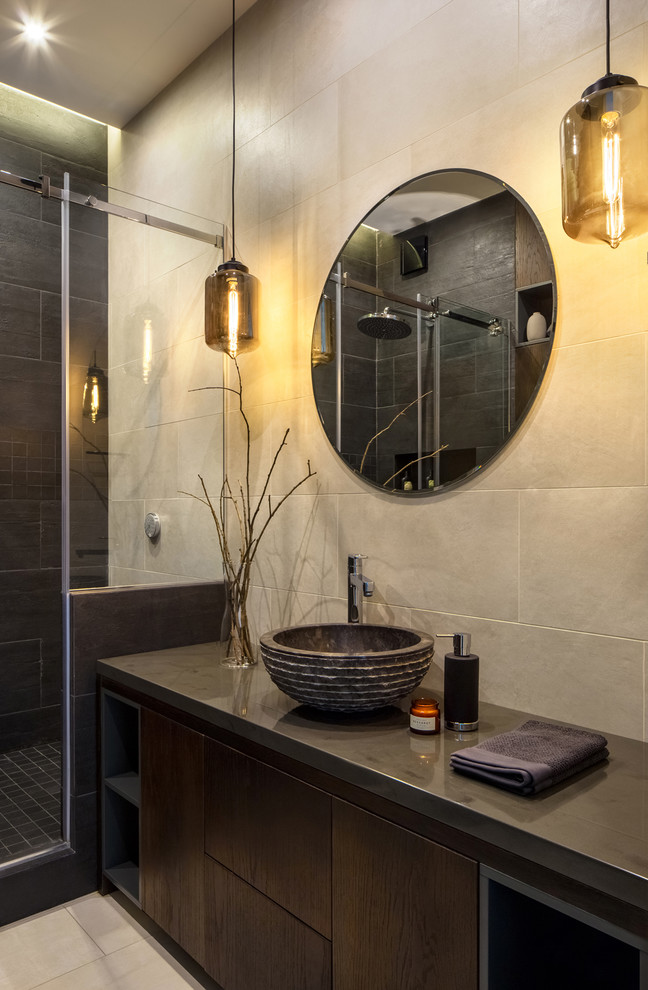This is an example of a small contemporary 3/4 wet room bathroom in Moscow with flat-panel cabinets, dark wood cabinets, a wall-mount toilet, black tile, porcelain tile, beige walls, ceramic floors, a vessel sink, solid surface benchtops, beige floor, a sliding shower screen and black benchtops.