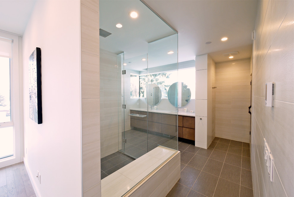 Trendy gray tile and porcelain tile walk-in shower photo in Calgary with an undermount sink, flat-panel cabinets, medium tone wood cabinets, quartzite countertops and a one-piece toilet
