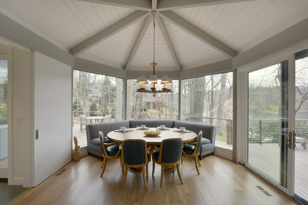 This is an example of a midcentury dining room in New York with no fireplace and light hardwood floors.