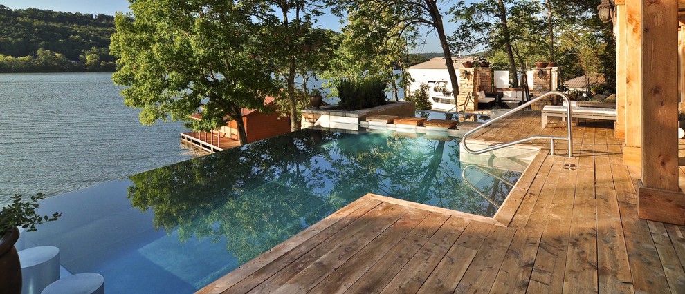 Pool - rustic backyard custom-shaped infinity pool idea
