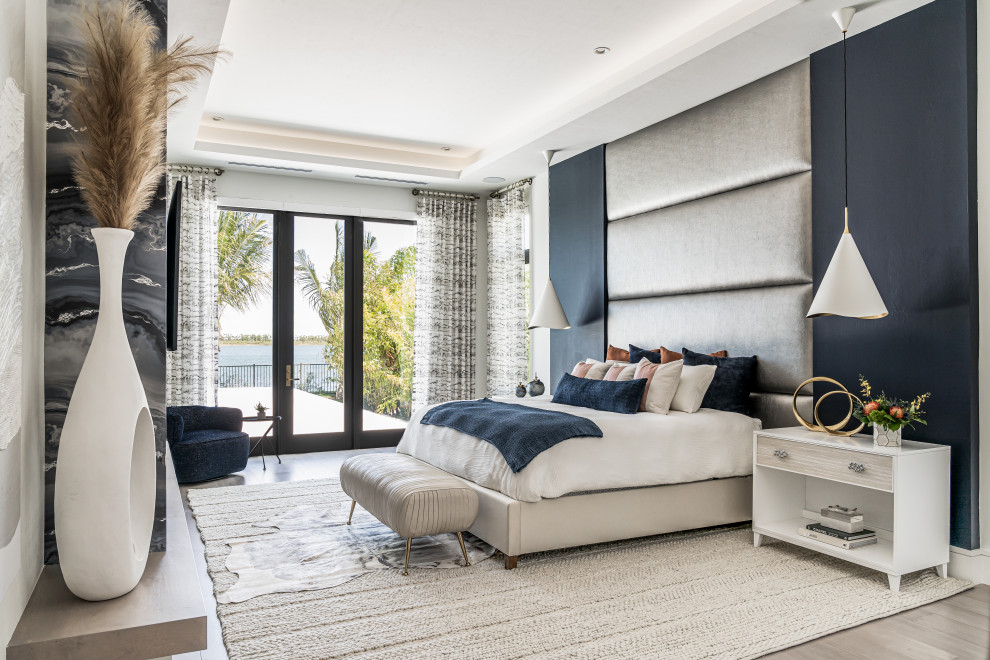 Design ideas for a modern master bedroom in Miami with laminate floors and grey floor.