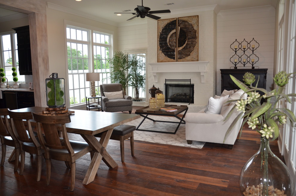 Inspiration for a mid-sized transitional formal open concept living room in New Orleans with white walls, medium hardwood floors, a standard fireplace, a brick fireplace surround and no tv.