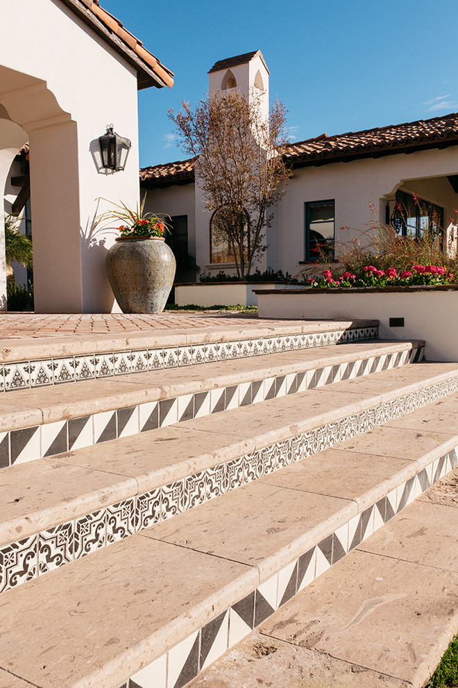 Design ideas for an expansive traditional backyard formal garden in Phoenix with natural stone pavers.