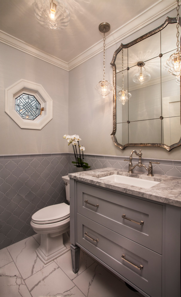 This is an example of a small traditional cloakroom in Seattle with shaker cabinets, blue cabinets, a two-piece toilet, blue tiles, porcelain tiles, blue walls, porcelain flooring, a submerged sink, quartz worktops, white floors, white worktops, a freestanding vanity unit and wainscoting.