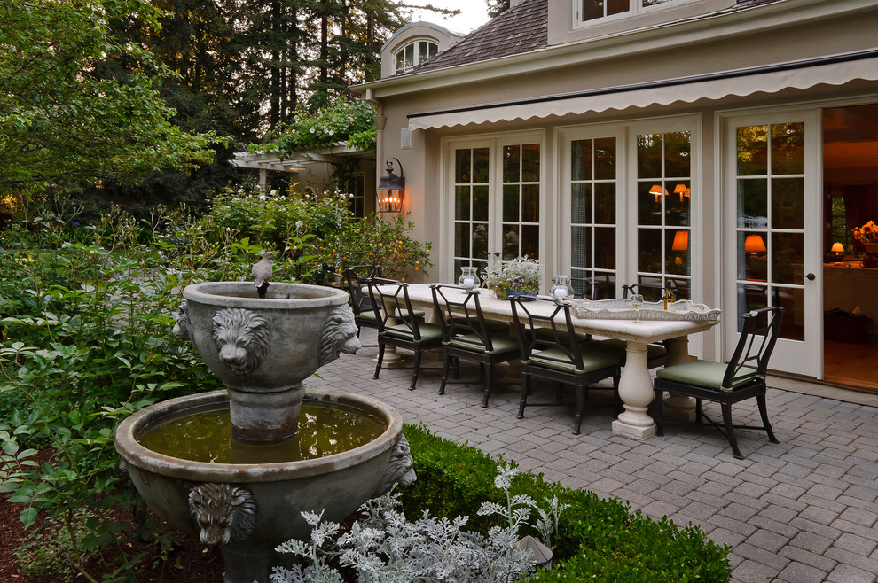 Design ideas for a backyard patio in San Francisco with a water feature and an awning.