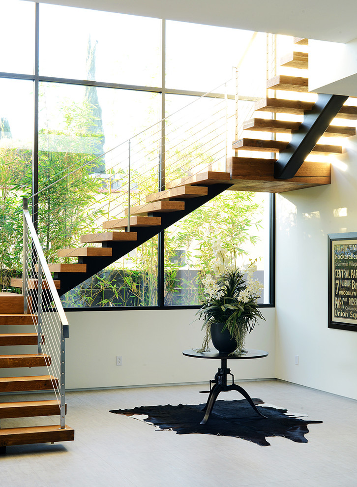 Contemporary wood staircase in Los Angeles with open risers.