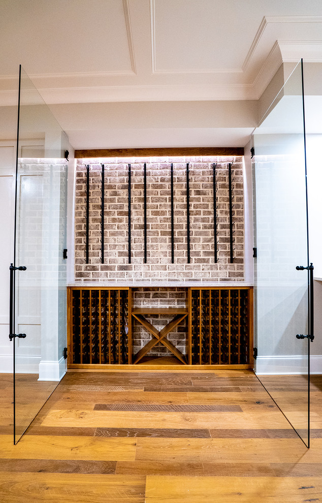 Small contemporary wine cellar in Atlanta with medium hardwood floors, display racks and brown floor.