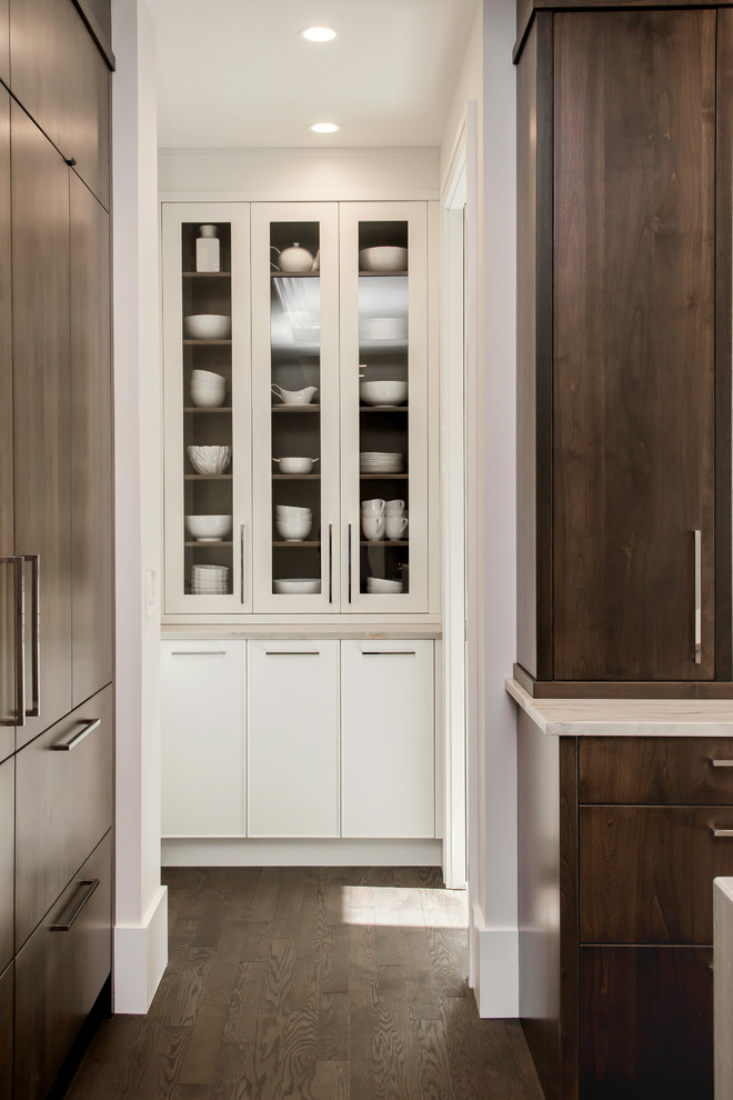 Large transitional l-shaped medium tone wood floor kitchen pantry photo in Calgary with a double-bowl sink, flat-panel cabinets, marble countertops, white backsplash, stone slab backsplash, paneled appliances and an island