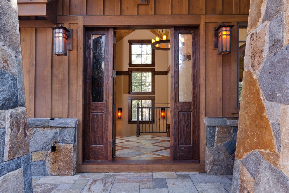 Large mountain style front door photo in Seattle with brown walls and a dark wood front door