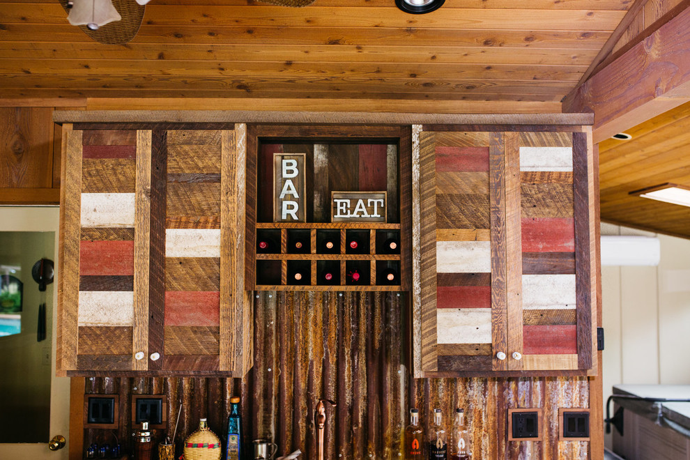 Inspiration for a mid-sized rustic l-shaped ceramic tile and brown floor eat-in kitchen remodel with an integrated sink, shaker cabinets, medium tone wood cabinets, brown backsplash, wood backsplash and a peninsula