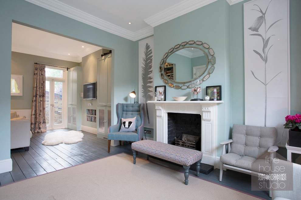 This is an example of a large traditional open concept living room in London with white walls, a standard fireplace and a plaster fireplace surround.