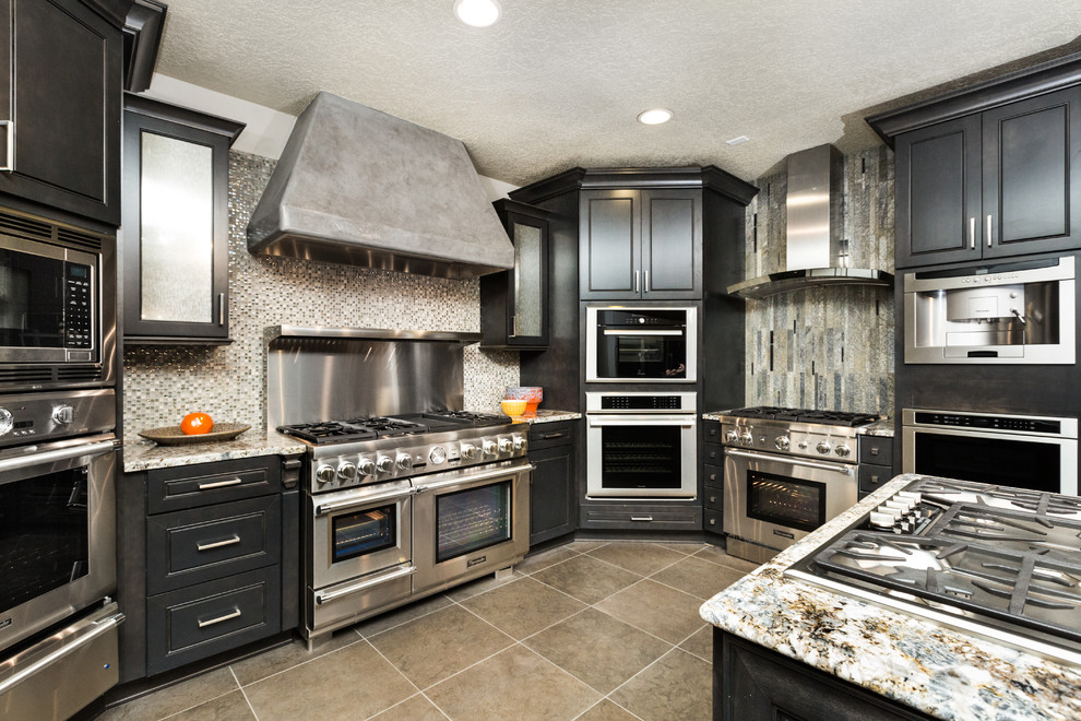 Kitchen - mid-sized transitional porcelain tile kitchen idea in Albuquerque with granite countertops, glass tile backsplash, stainless steel appliances and an island