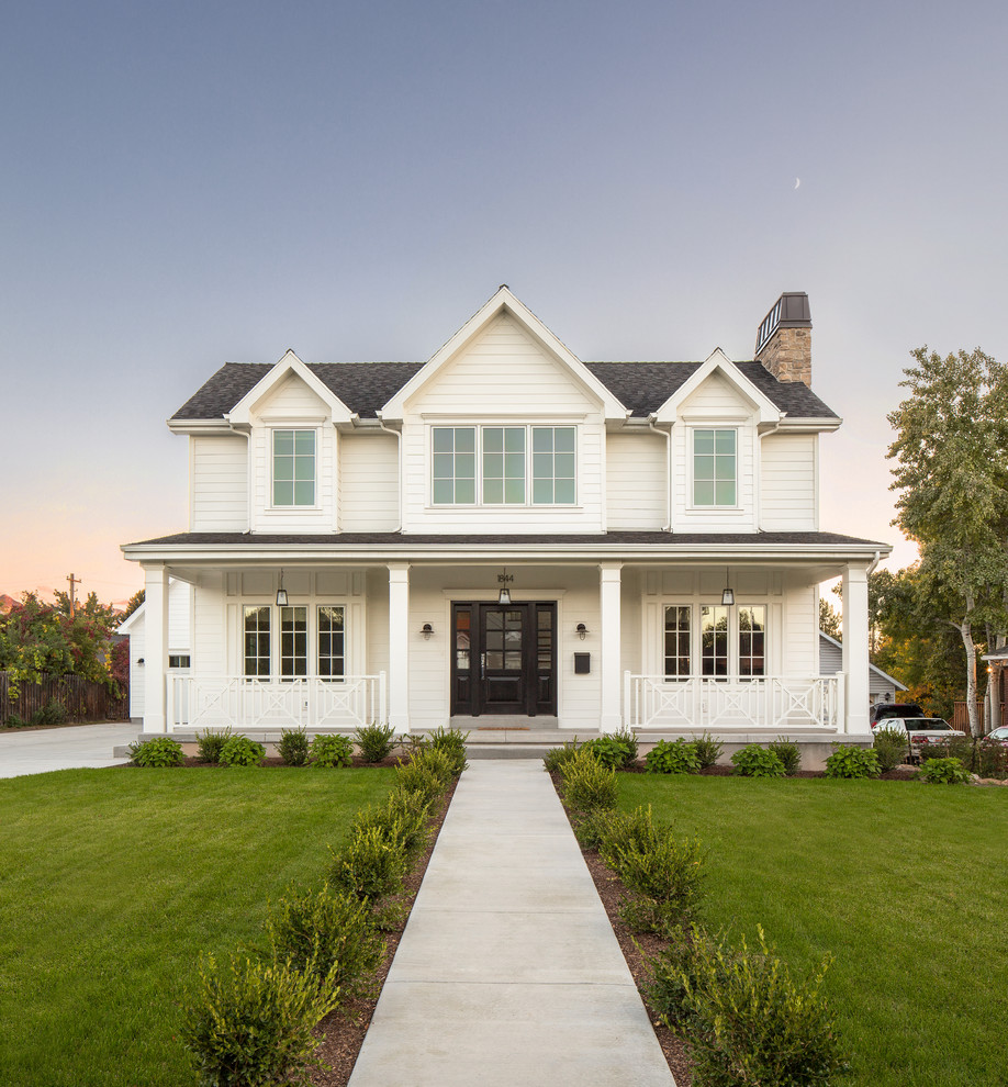 Inspiration for a country two-storey white house exterior in Salt Lake City with a gable roof and a shingle roof.