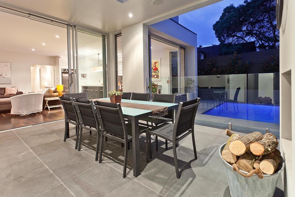 Inspiration for a transitional backyard patio in Melbourne with a roof extension.