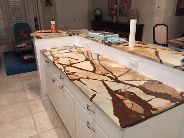 Kitchen - porcelain tile kitchen idea in Miami with an undermount sink, granite countertops, white backsplash, porcelain backsplash, stainless steel appliances and an island